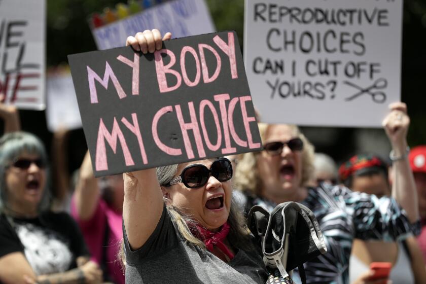 FILE - In this May 21, 2019 file photo, a group gathers to protest abortion restrictions at the State Capitol in Austin, Texas. Arguments over a Texas law requiring that health care clinics bury or cremate fetal remains from abortions and miscarriages are set for a federal appeals court in New Orleans. A Texas judge blocked the law last year. U.S. District Judge David Ezra ruled that many clinics would be unable to meet the law’s requirements, thus creating unconstitutional obstacles for women seeking abortions. A three-judge panel of the 5th U.S. Circuit Court of Appeals hears arguments Thursday, Sept. 5. (AP Photo/Eric Gay, File)
