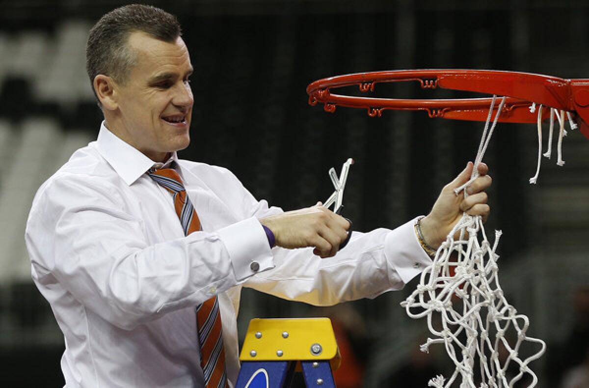 Florida Coach Billy Donovan takes his turn at cutting down the net after the Gators defeated the Kentucky Wildcats for the Southeastern Conference tournament title.