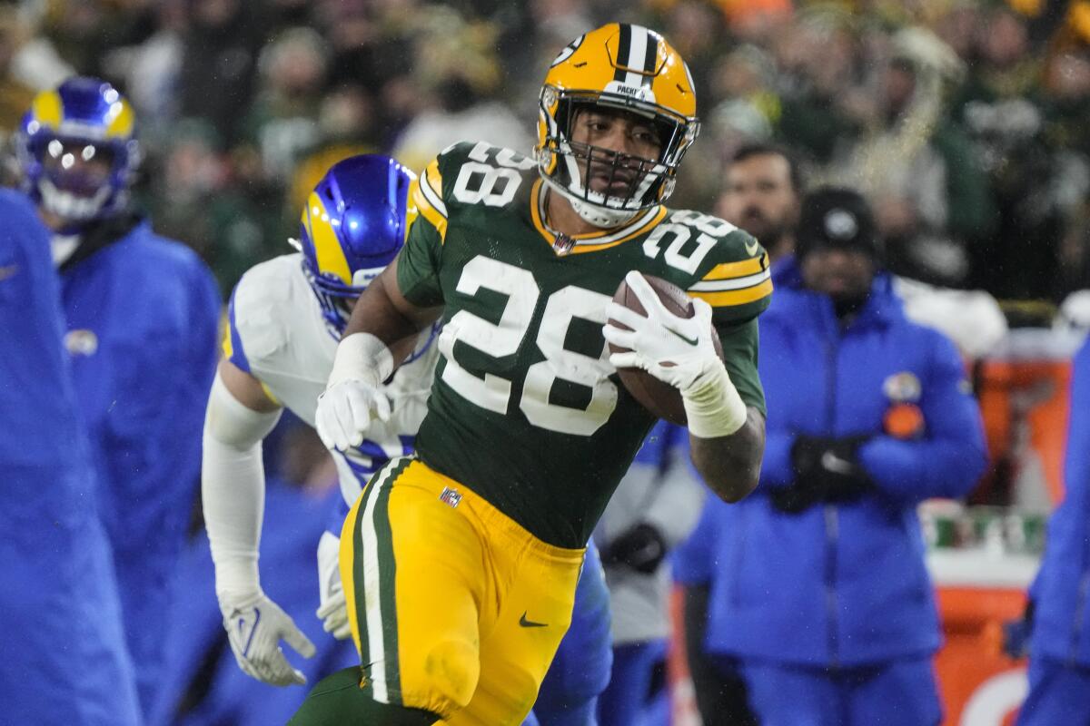 Green Bay Packers running back AJ Dillon carries the ball during the third quarter.