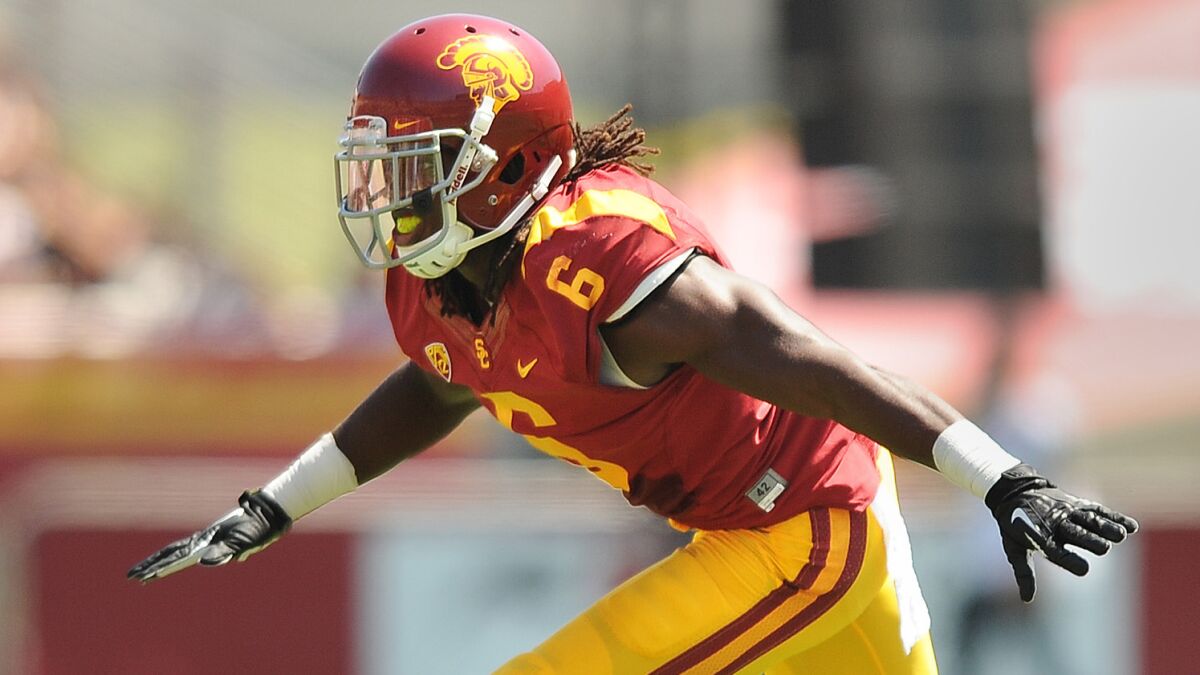 USC cornerback Josh Shaw celebrates after making a tackle during a game against Boston College in September 2013. Shaw suffered two high ankle sprains while rescuing his nephew from a swimming pool Monday.