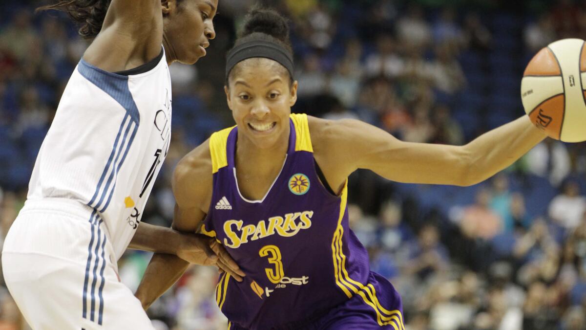 Sparks forward Candace Parker, right, drives past Minnesota Lynx forward Devereaux Peters during the first half of Tuesday's game.