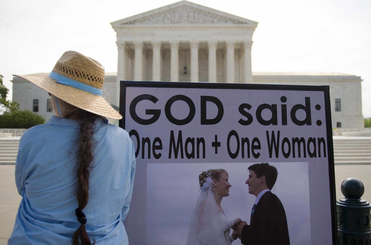 An anti-same-sex marriage demonstrator stands in front of the U.S. Supreme Court in Washington on June 18, awaiting the court's landmark decision.