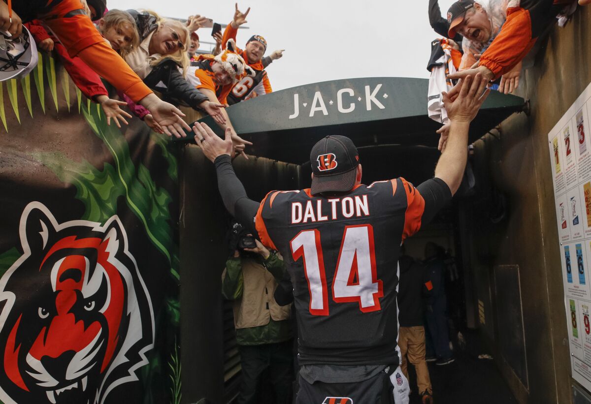 Cincinnati Bengals quarterback Andy Dalton greets fans as he walks to the locker room.