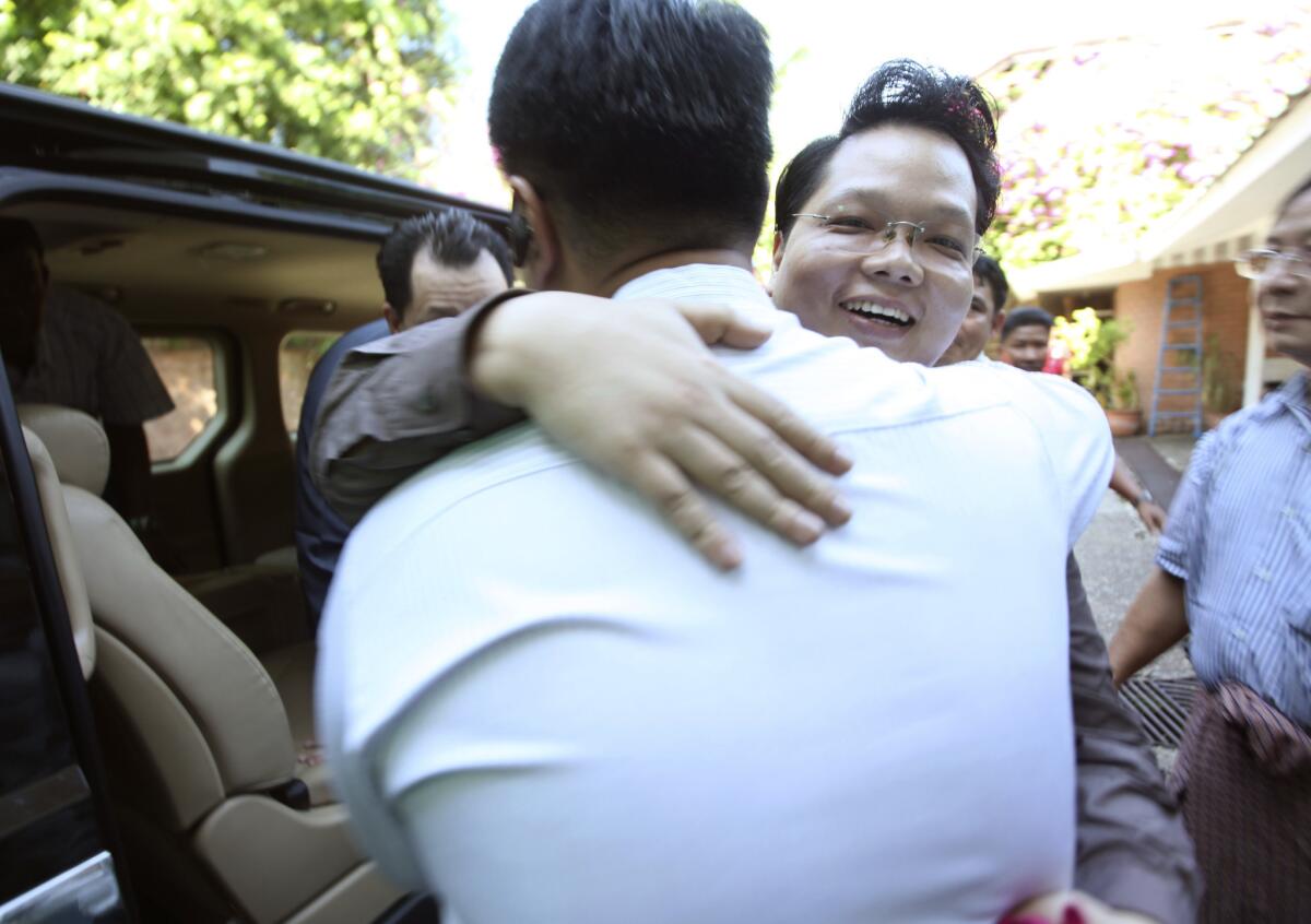 Aye Ne Win, right, a grandson of former dictator Gen. Ne Win, is welcomed by his younger brother Zwe Ne Win after his release Friday from Insein prison. He was one of 69 prisoners released during the day.