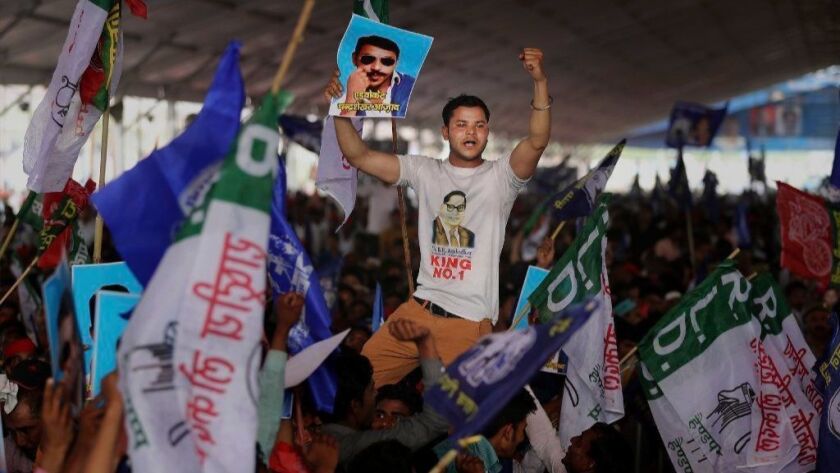 A demonstrator in Uttar Pradesh displays a picture of Dalit leader Chandrasekhar Azad at a rally in Deoband, India, in April.