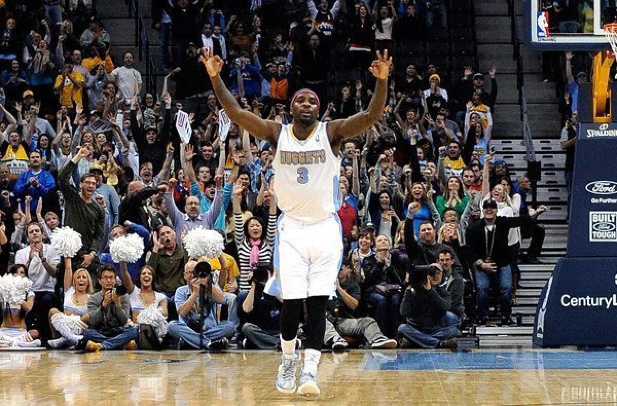 Nuggets point guard Ty Lawson celebrates a three-point basket against the Atlanta Hawks during the fourth quarter.