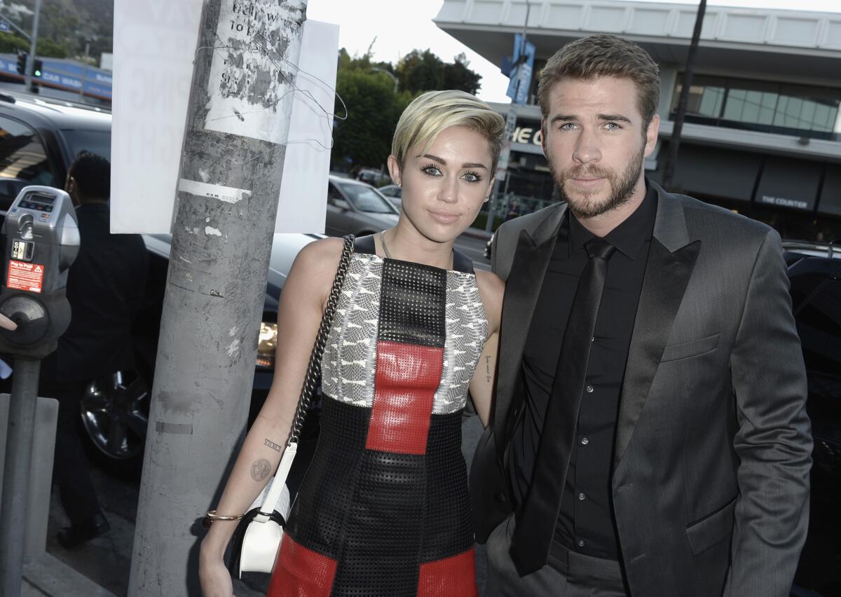 Miley Cyrus and Liam Hemsworth attend the premiere of "Paranoia" in Los Angeles in August 2013.