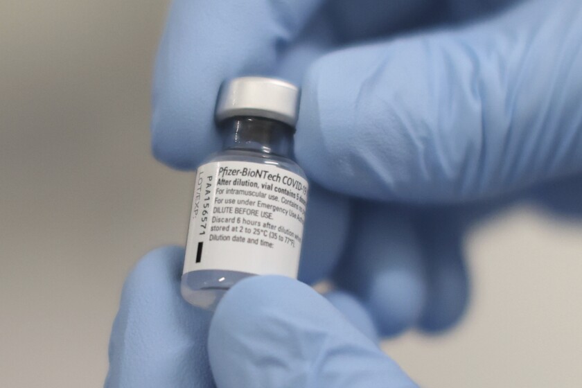 A phial of the Pfizer-BioNTech COVID-19 vaccine at the Royal Victoria Hospital, in Belfast, Tuesday Dec. 8, 2020. 