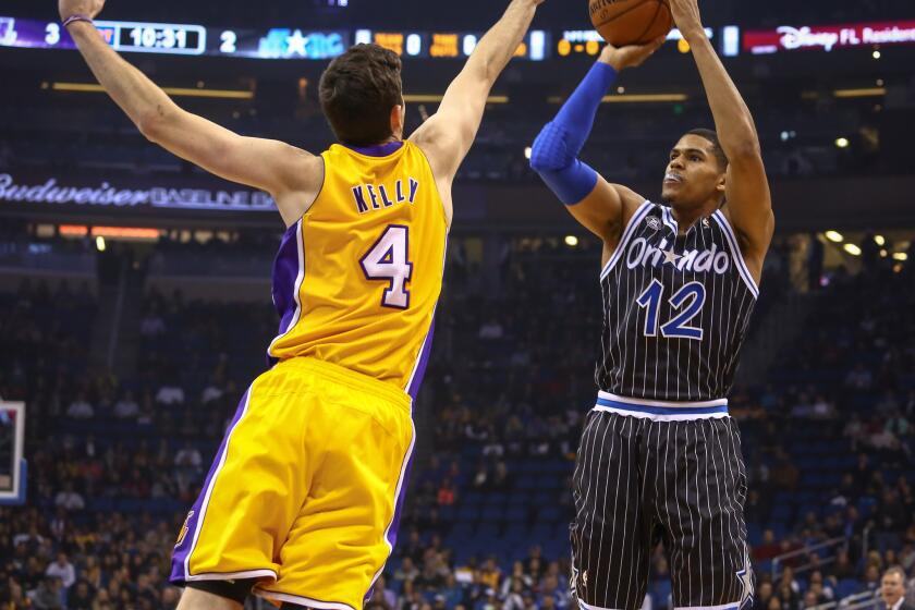 Magic forward Tobias Harris shoots over the outstretched hand of Lakers forward Ryan Kelly last season.