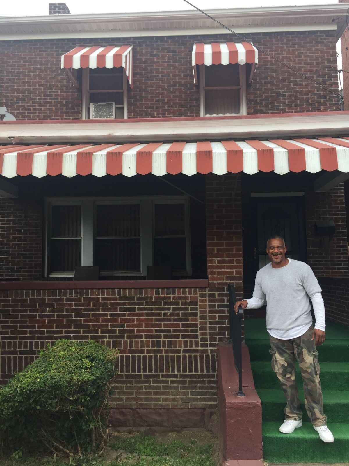 Archie Donald, father of Aaron Donald, stands on the porch of the Rams star's childhood home in Pittsburgh.
