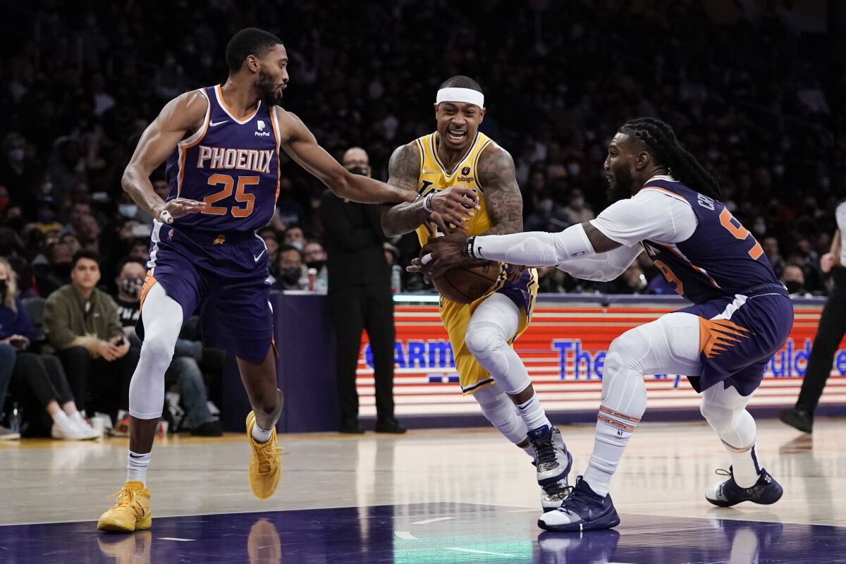 Lakers' Isaiah Thomas is double-teamed by Phoenix Suns' Mikal Bridges and Jae Crowder.