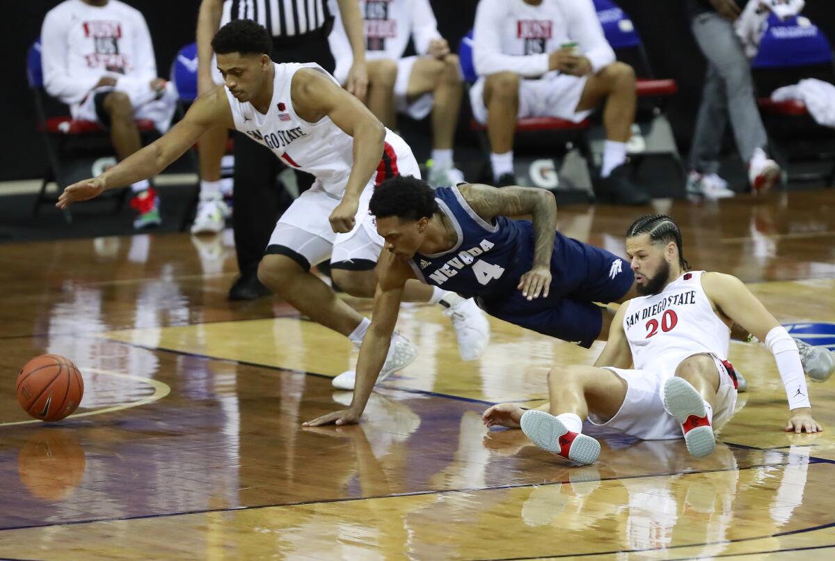 Matt Mitchell, left, and Jordan Schakel, right, create a turnover Friday against Nevada in a Mountain West semifinal.