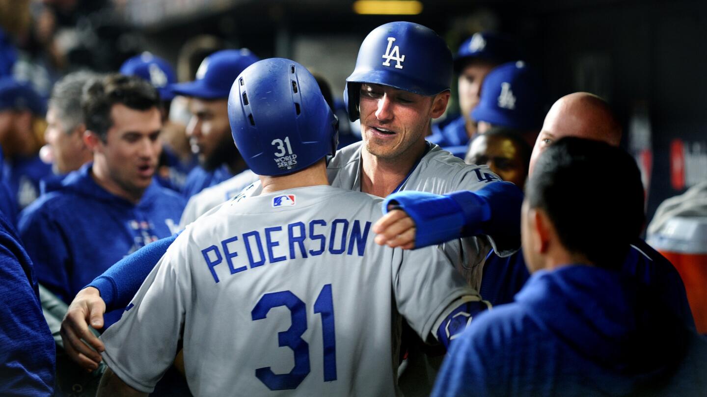 The Dodgers' Cody Bellinger hugs Joc Pederson after Pederson's three-run homer in the ninth inning.
