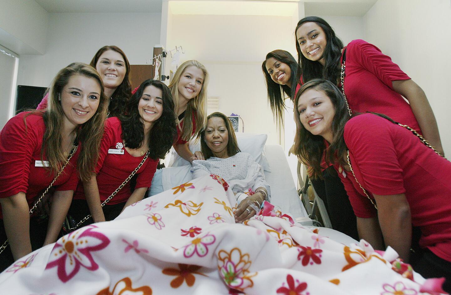The 2013 Rose Court with patient Dana Thompson, of Glendale, at Glendale Adventist Medical Center in Glendale for the resumed annual visit by the Rose Court to visit staff and patients on Tuesday, November 13, 2012.