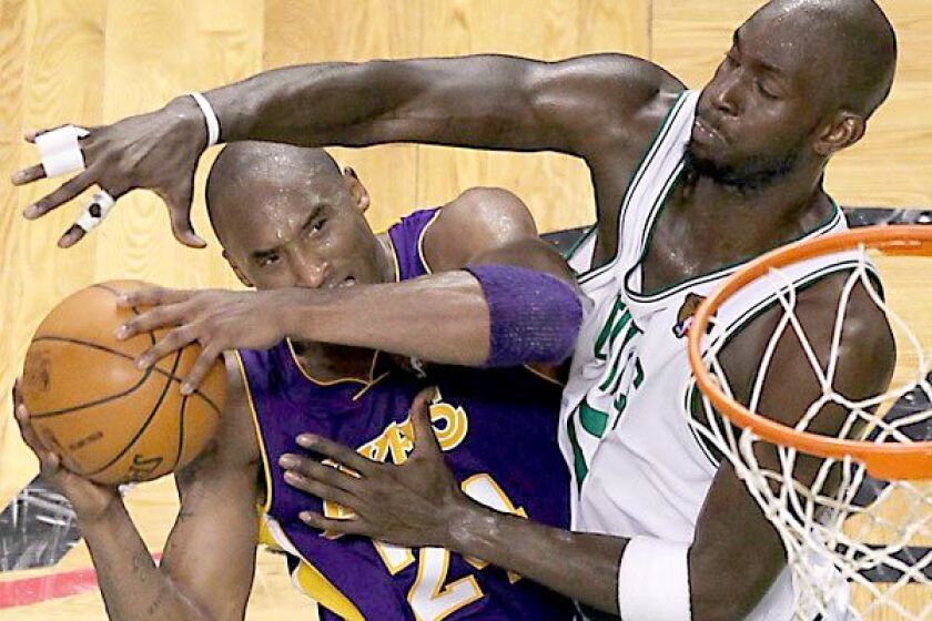 Celtics forward Kevin Garnett forces Kobe Bryant into a difficult shot in the fourth quarter of Game 5 in the 2010 Finals.