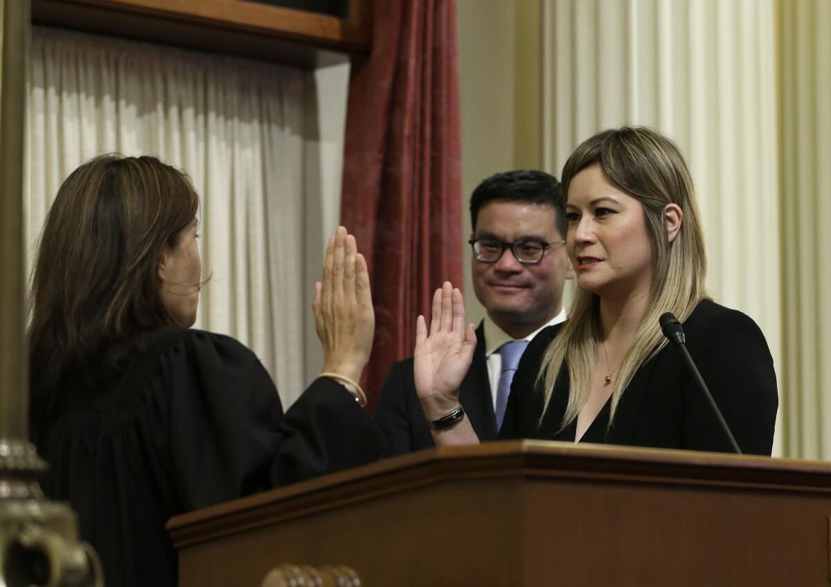 Ling Ling Chang is sworn in to the California Senate by Chief Justice Tani Cantil-Sakauye, as Chang's husband, Andrew Wong, looks on.