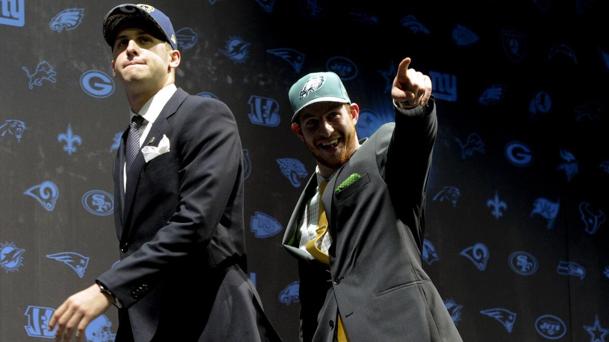 Jared Goff and Carson Wentz exit the NFL draft stage in Chicago after getting selected first and second overall in 2016.