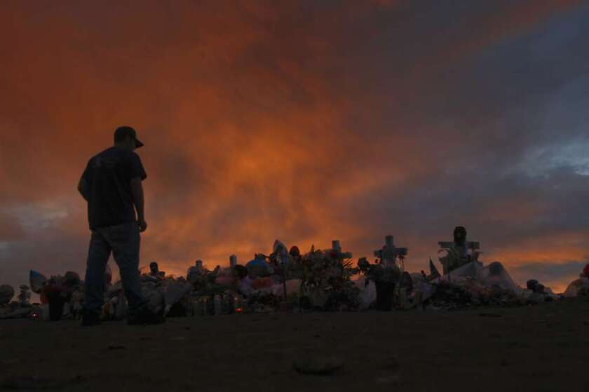 A study finds that people who are mentally ill are less likely to commit crimes when they take antipsychotic or mood-stabilizing medications. Above, a man visits a memorial for those killed in an Aurora, Colo., movie theater in 2012. The admitted shooter has pleaded not guilty by reason of insanity.