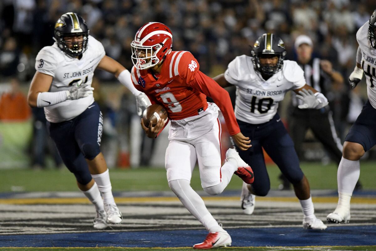 Mater Dei quarterback Bryce Young breaks into the St. John Bosco secondary during a Trinity League game on Oct. 13, 2018.