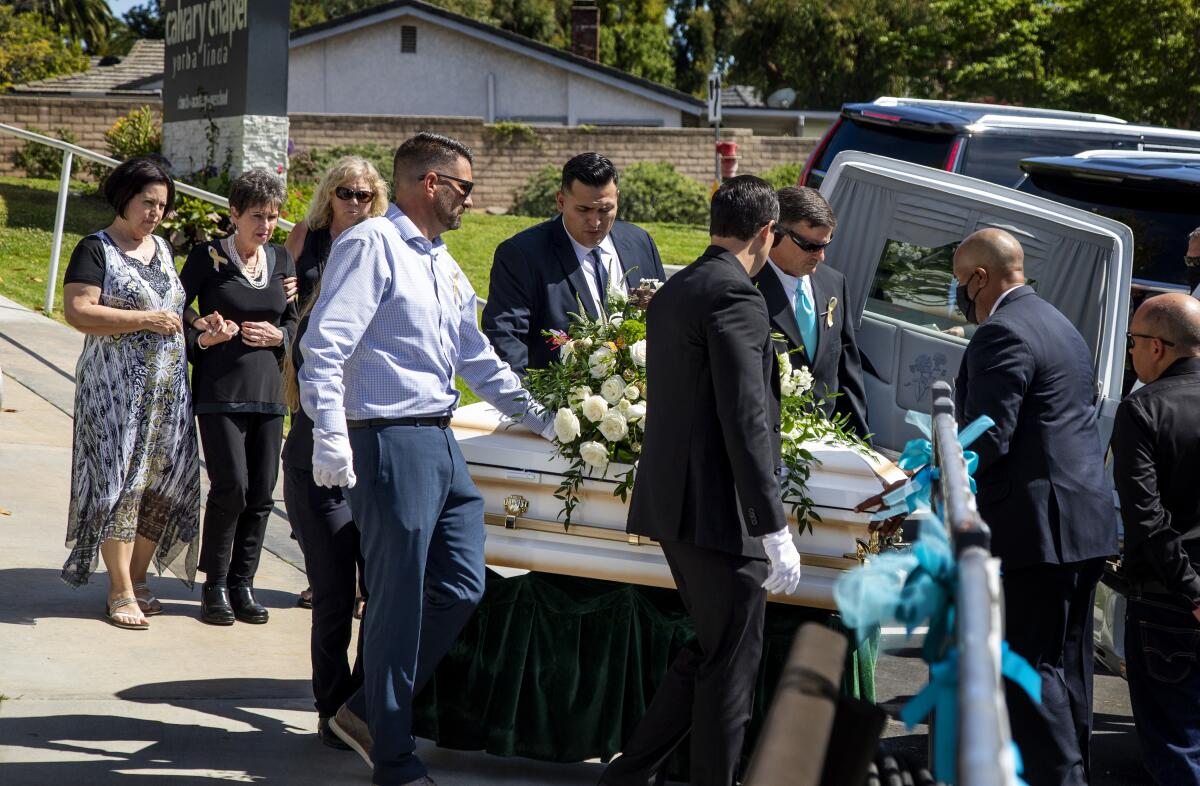 Pallbearers carry the casket of 6-year-old Aiden Leos after a funeral service at Calvary Chapel Yorba Linda.