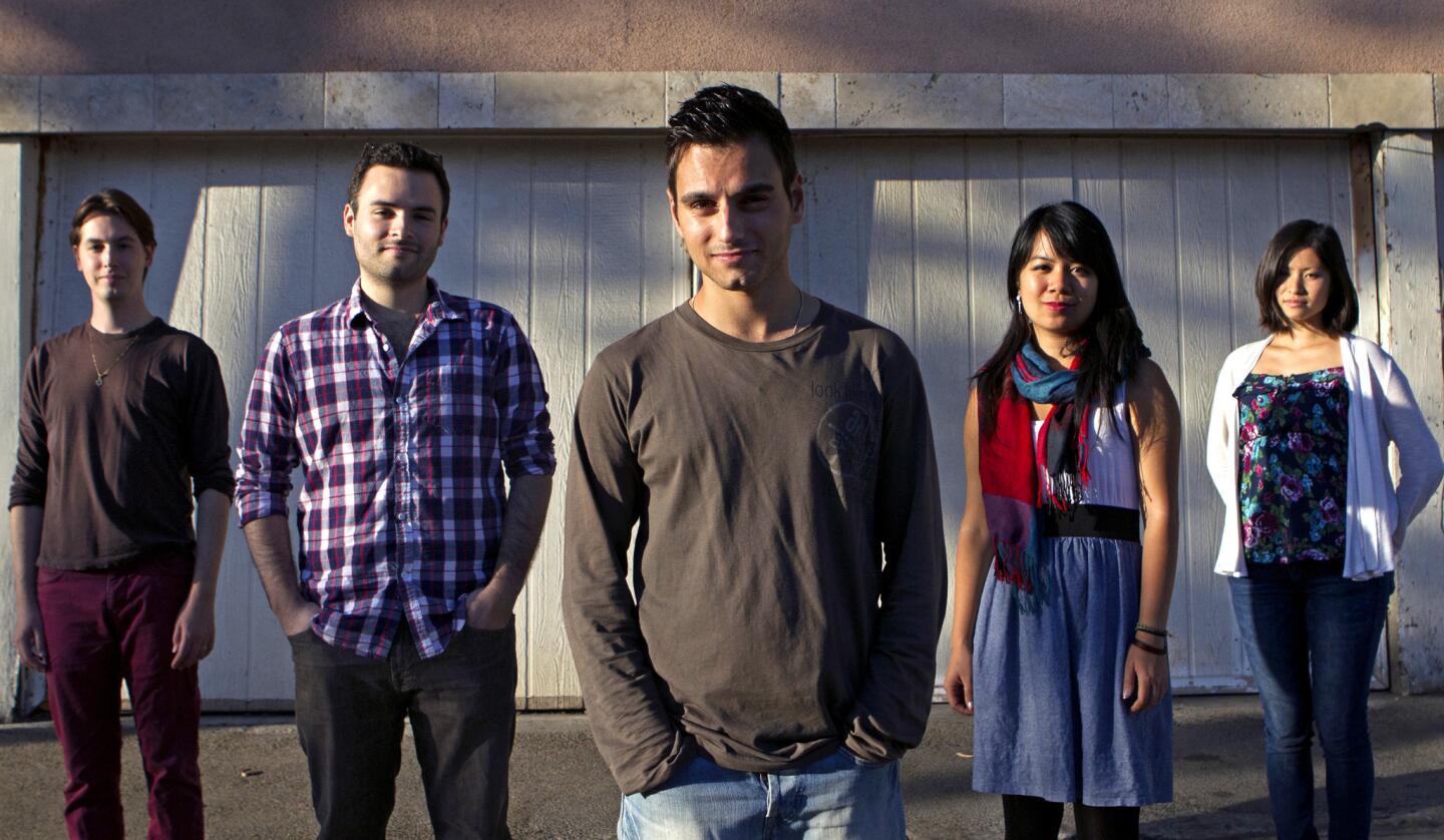 Game makers Michael Fallik, from left, Antonio Andrade, Miguel Oliveira, Kayee Au and Tiffanie Mang took part in creating an in-development game, "Thralled," where the player follows a former slave who searches for her son and relives her past traumas during the transatlantic slave trade.