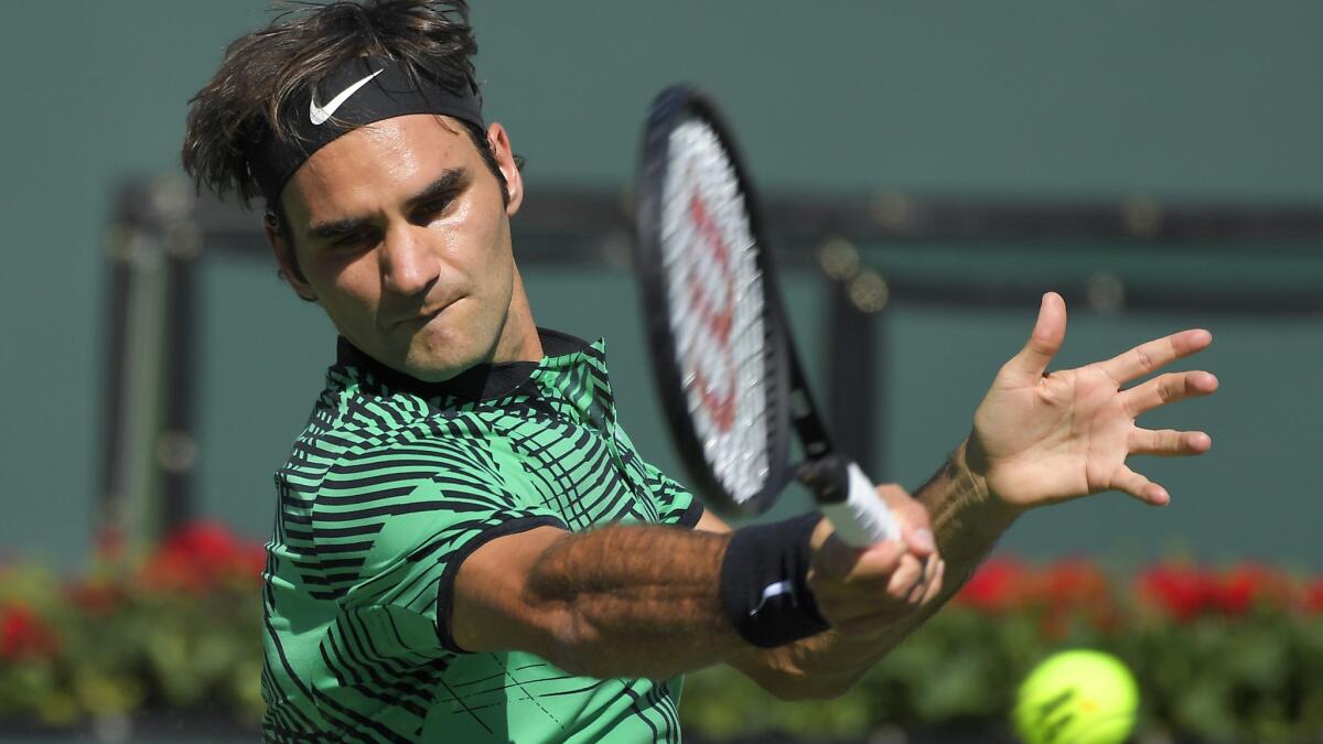 Roger Federer returns a shot against Stan Wawrinka in the men's championship match of the BNP Paribas Open on Sunday at Indian Wells Tennis Garden.