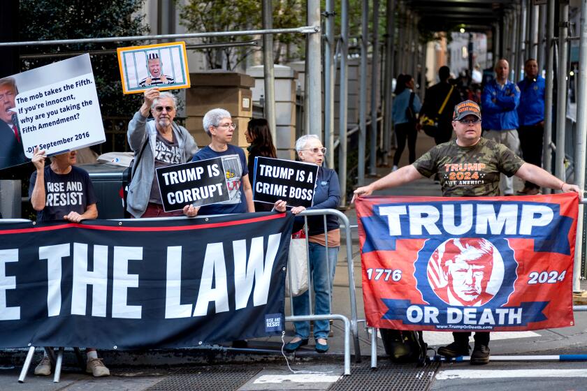 Protesters gather before former President Donald Trump arrives in a motorcade for a deposition in New York Thursday, April 13, 2023. (AP Photo/Craig Ruttle)