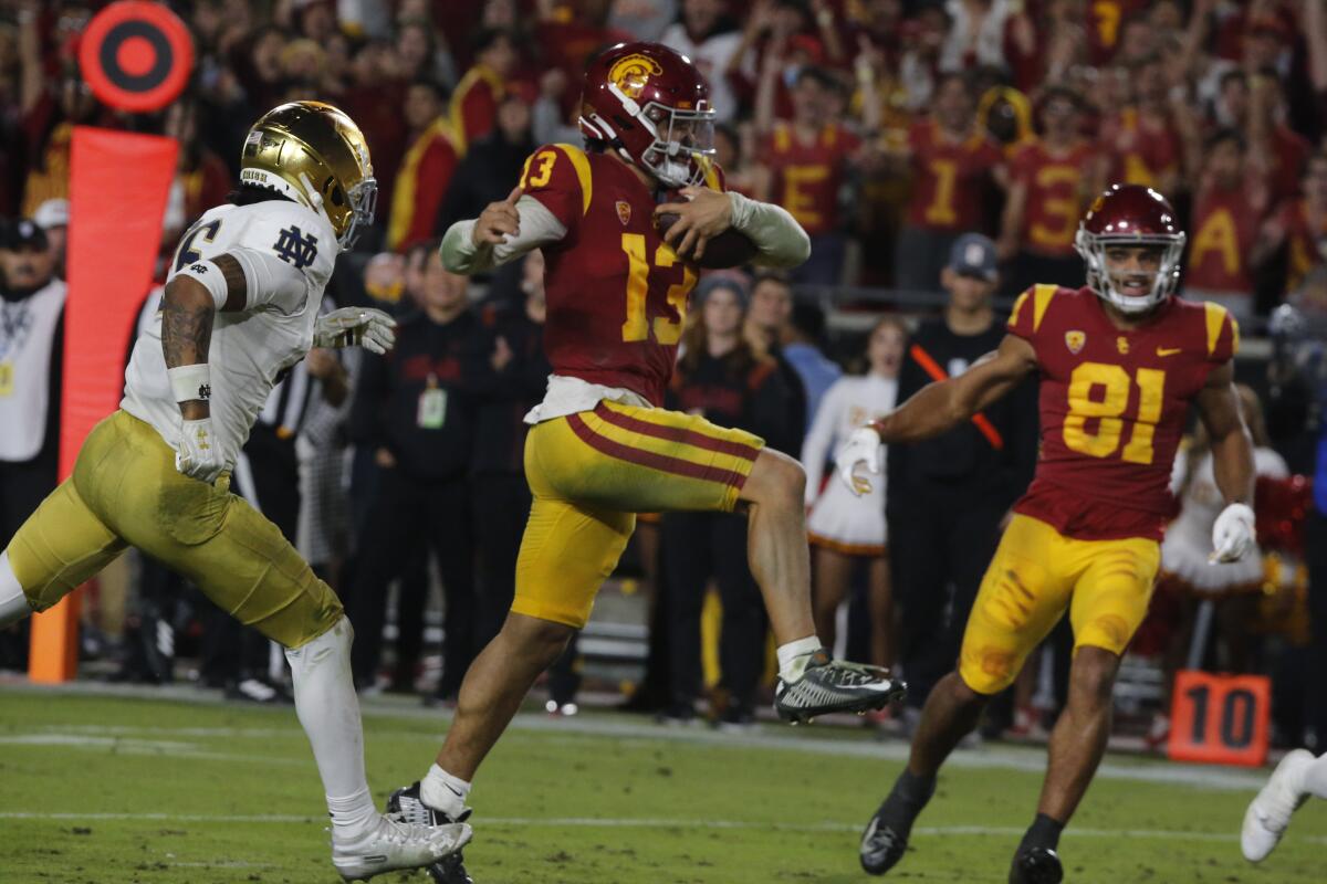 USC quarterback Caleb Williams leaps into the end zone for a touchdown against Notre Dame.