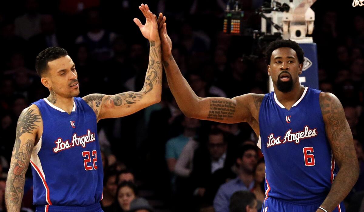 Clippers forward Matt Barnes, left, and center DeAndre Jordan, who combined for 25 points and 16 rebounds before sitting out the fourth quarter, celebrate after a foul is called against the Knicks on Wednesday night.