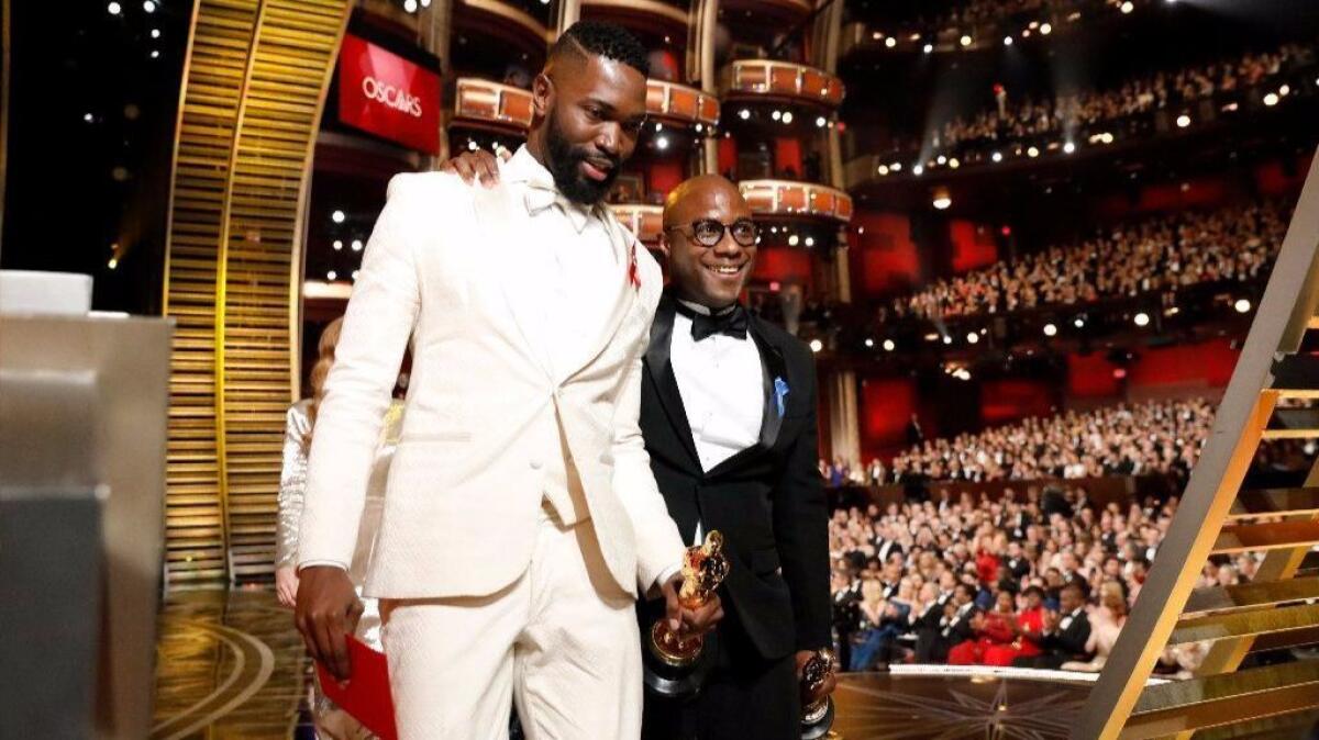 Tarell Alvin McCraney, left, and Barry Jenkins after accepting the 2016 Oscar for adapted screenplay for "Moonlight." (Al Seib / Los Angeles Times)