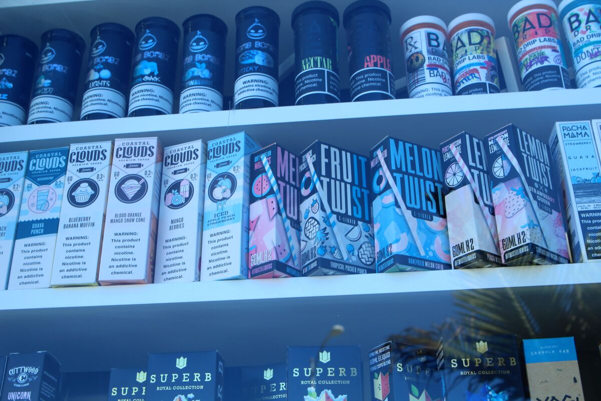 Vaping cartridges and other supplies are openly advertised in a street-facing window along Pacific Beach's Garnet Avenue.
