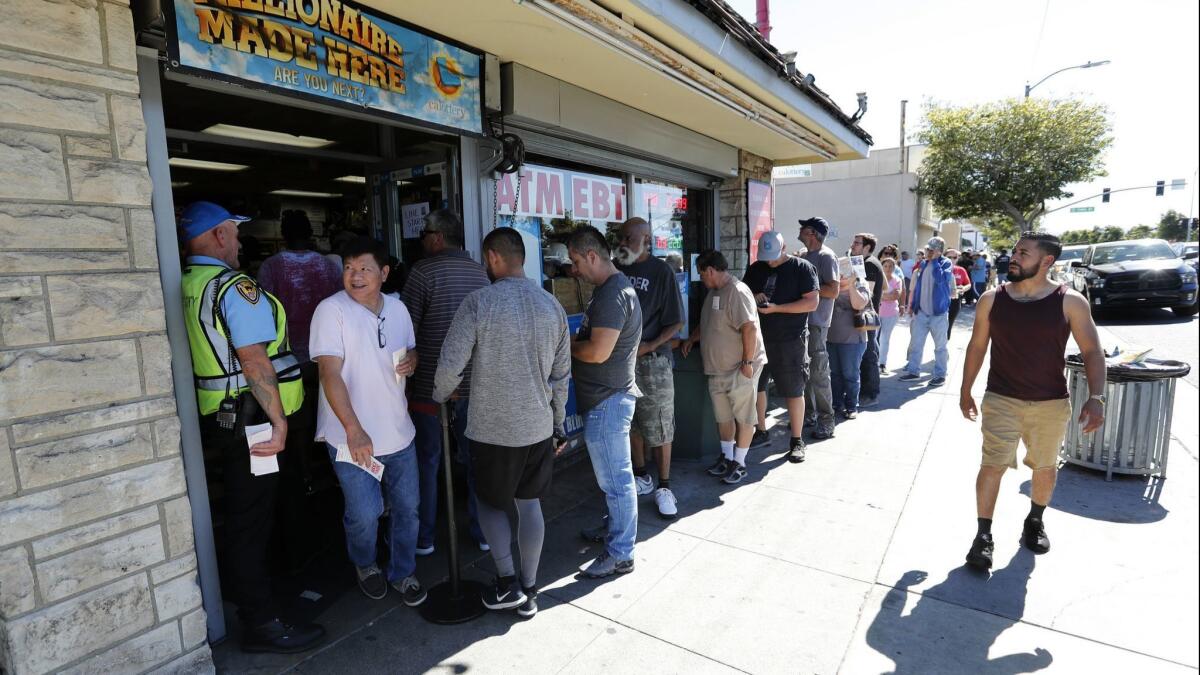 People wait in line outside of Bluebird Liquor in Hawthorne to buy Mega Millions lottery tickets in 2018.
