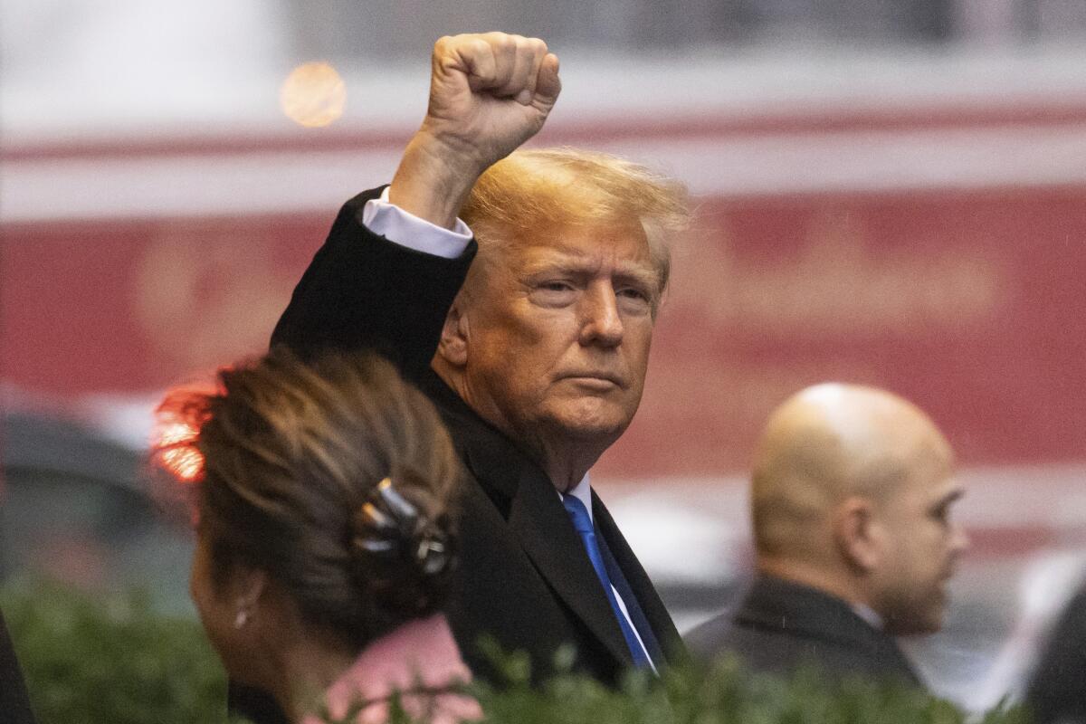 Donald Trump raises his fist 