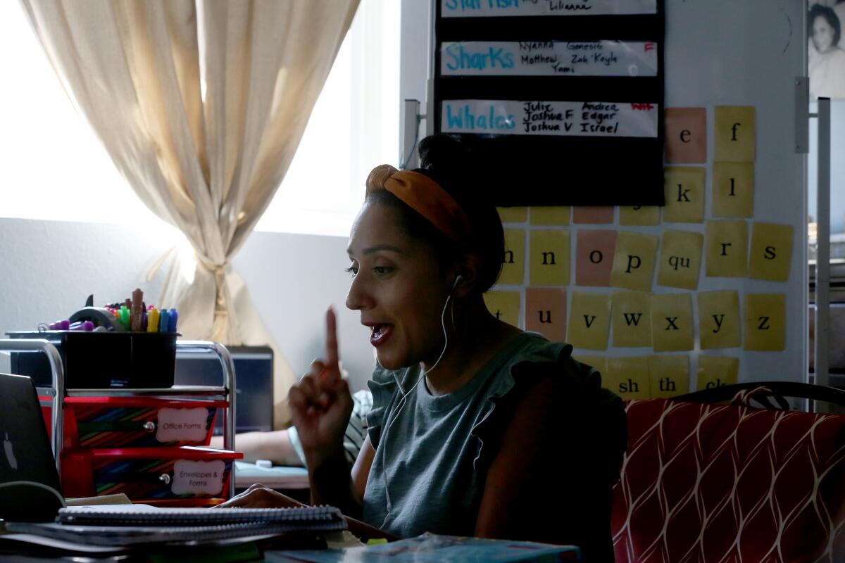 Fourth-grade teacher Rhiannon Chavez instructing her class remotely at a computer.