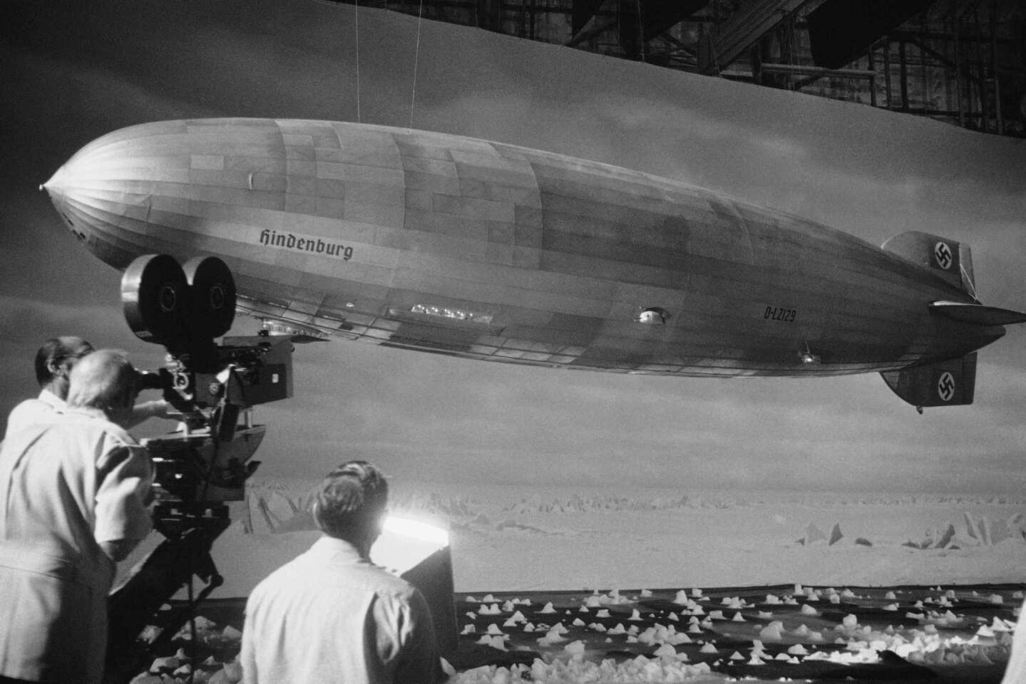 Special effects artists shoot the model of the dirigible the Hindenberg during the filming of Robert Wise's "The Hindenberg" on Aug. 18, 1974, at Universal Studios in Los Angeles.
