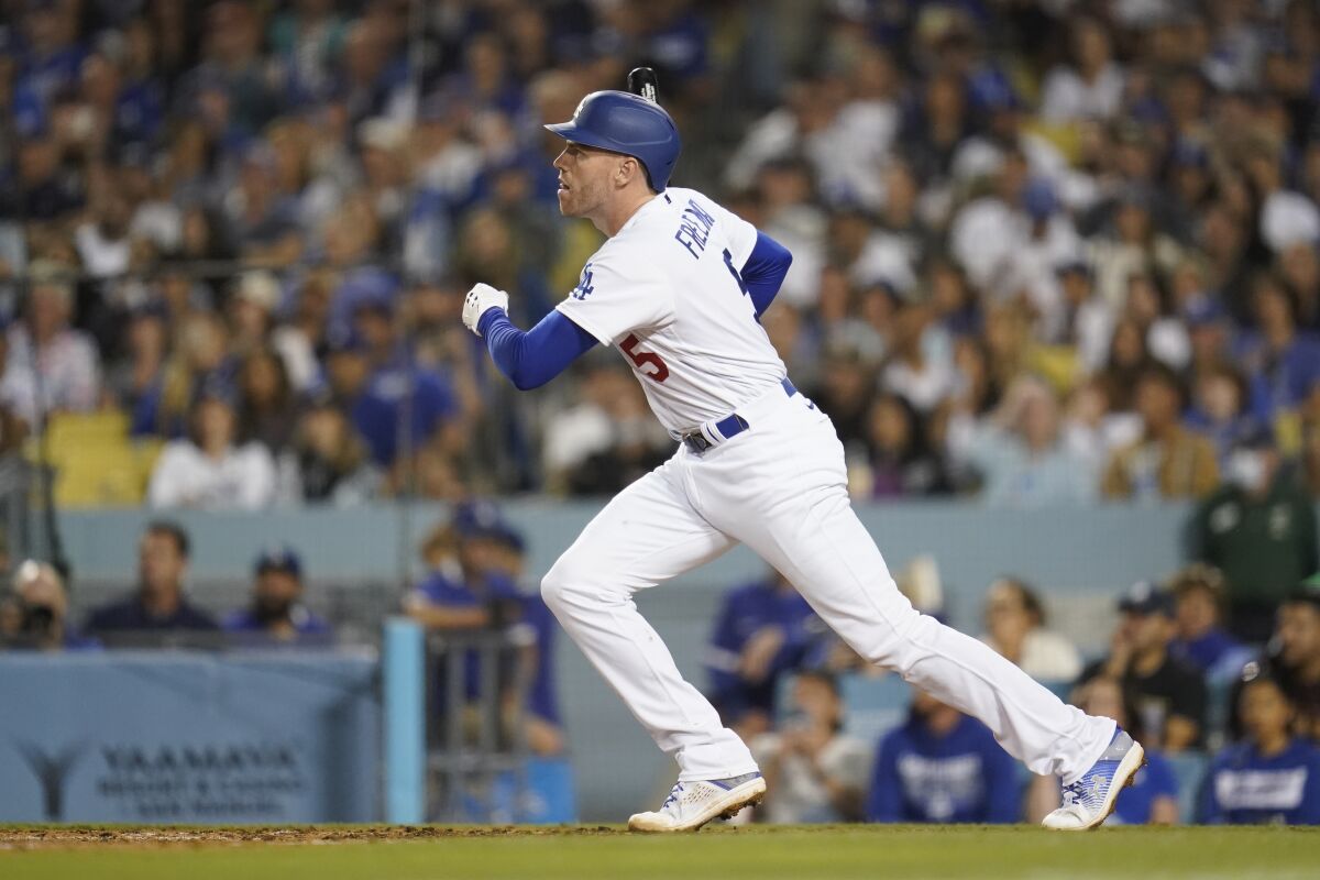 The Dodgers' Freddie Freeman runs after hitting a two-run single during the seventh inning July 9, 2022. 