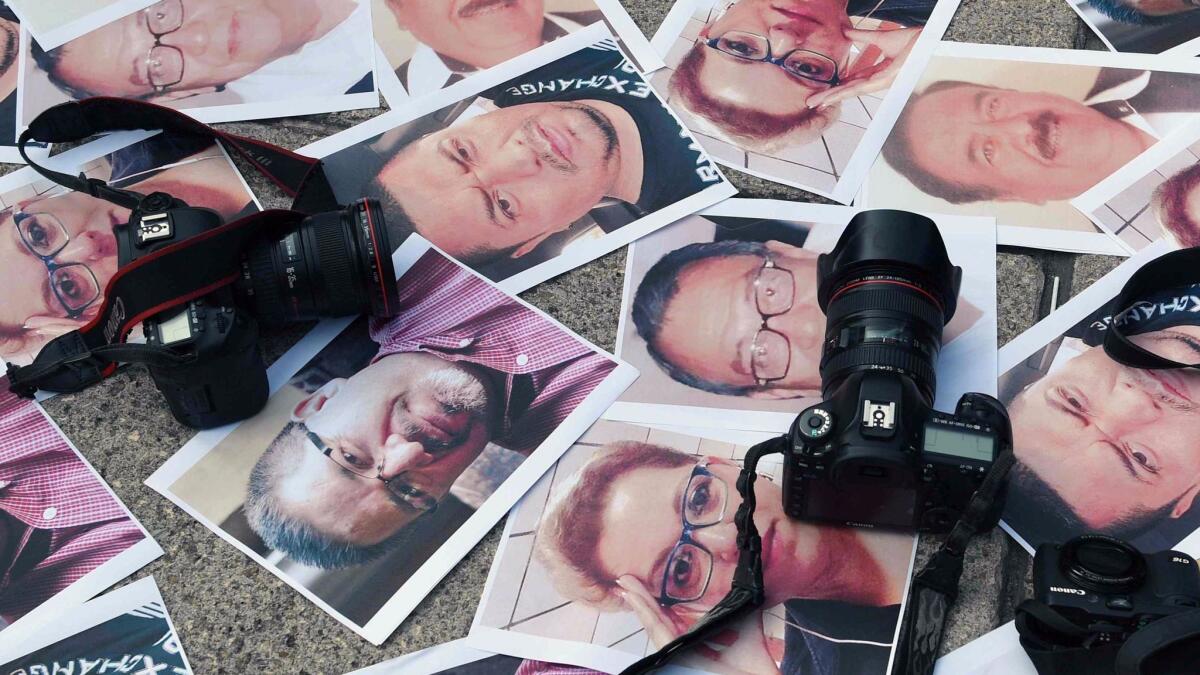 Cameras and pictures of journalists recently slain in different Mexican states are placed at the Angel of Independence square earlier this year.