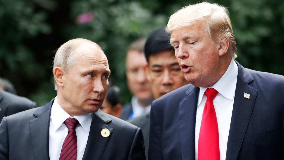 Russian President Vladimir Putin, left, and U.S. President Trump confer during the Asia-Pacific Economic Cooperation leaders' summit in Vietnam in November.