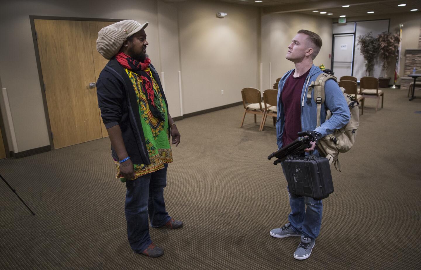 "Identity Evropa" founder and Cal State Stanislaus student Nathan Damigo, right, and Fela Uhuru chat as they prepare for students to attend a talk with Uhuru's Intro to Ethnic Studies class.