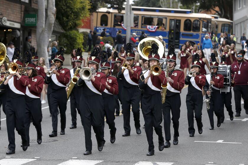 The Laguna Beach High marching band walk down Forest Ave. during the 56th annual Patriot's Day Parade in Laguna Beach on Saturday.
