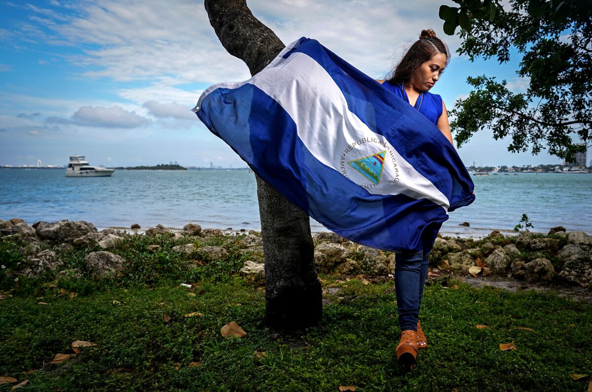 A woman holds a Nicaragua flag
