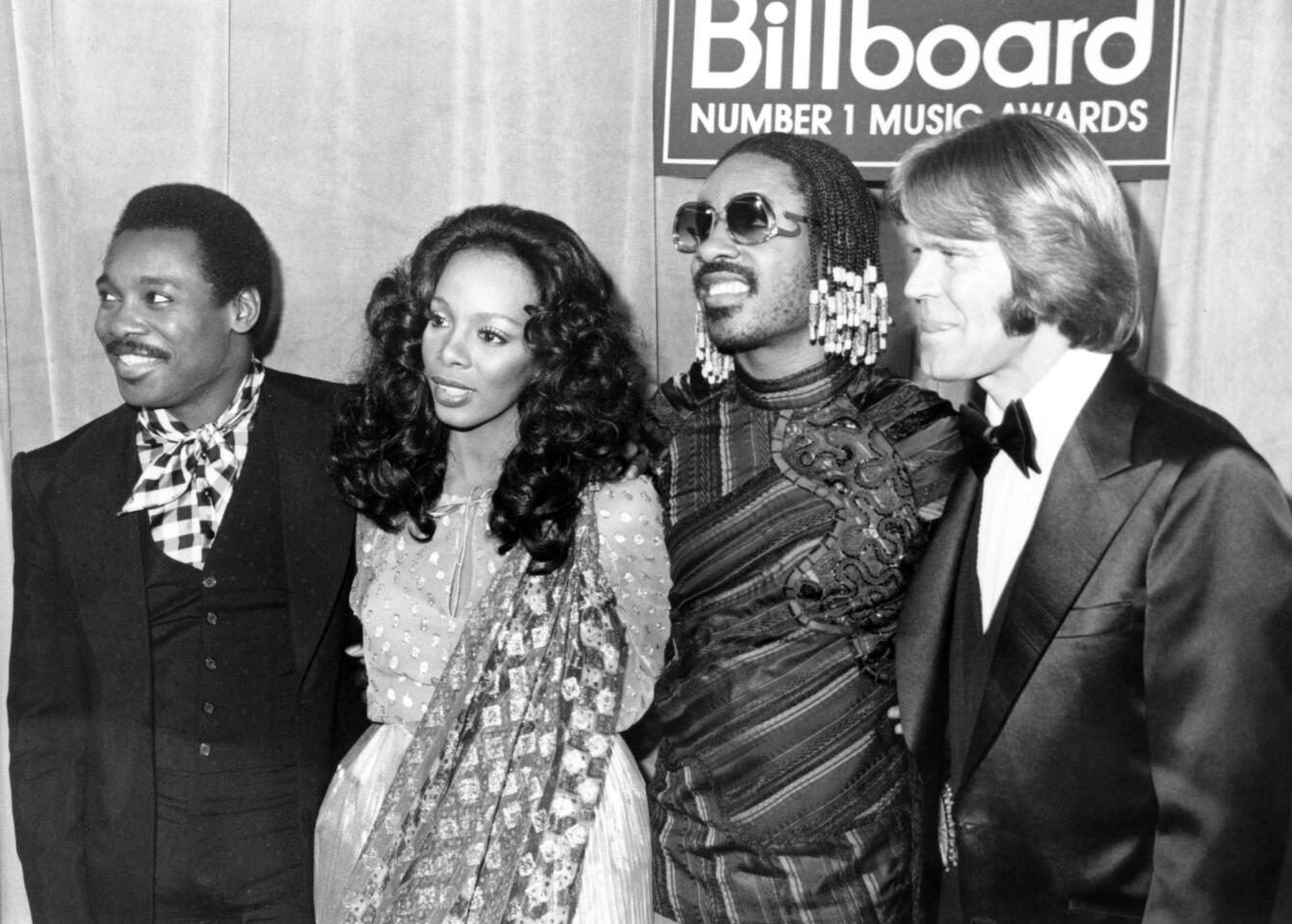 George Benson, left, Donna Summer, Stevie Wonder and Glen Campbell attend the 1980 "Billboard Number 1 Music Awards."