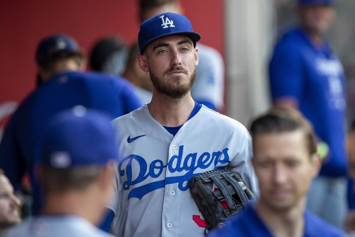 Los Angeles Dodgers' Cody Bellinger looks over in the dugout before a baseball game.