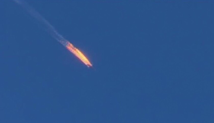A frame grab from video by Haberturk TV shows a Russian warplane on fire before crashing on a hill as seen from Hatay province, Turkey, on Nov. 24.