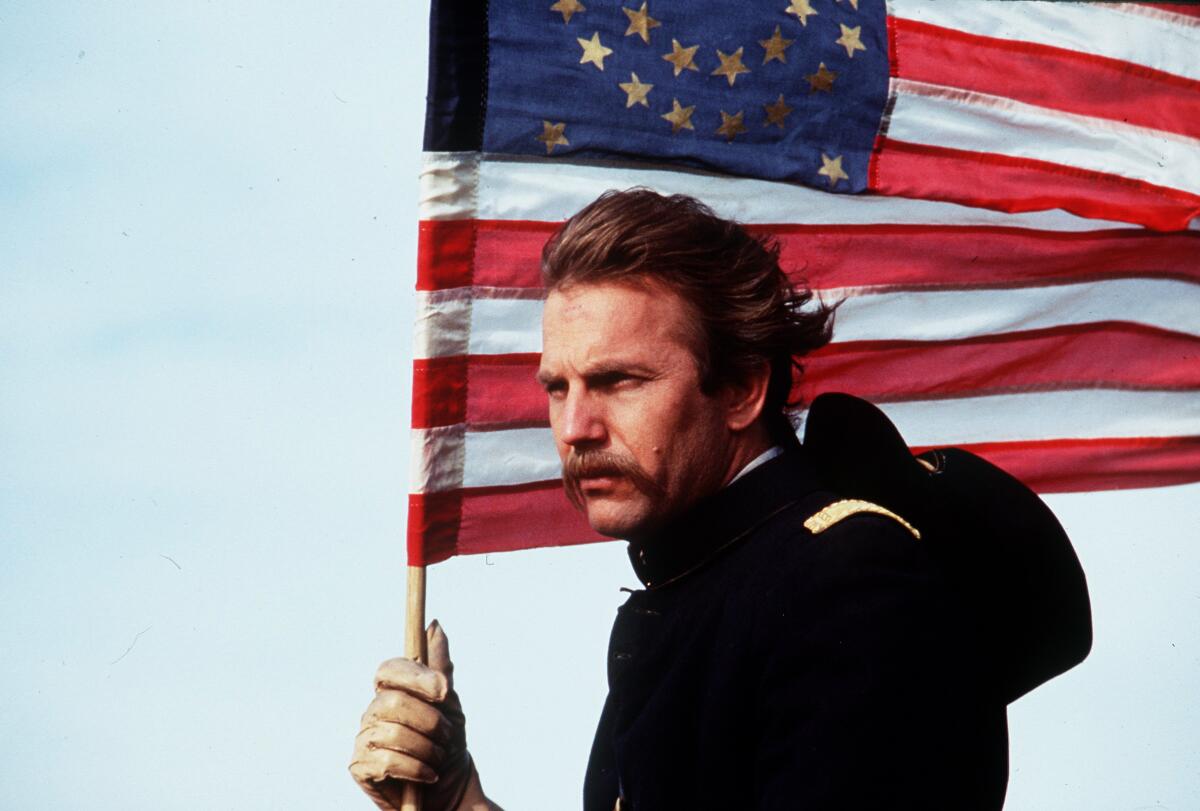 A Civil War solder carries an American flag.