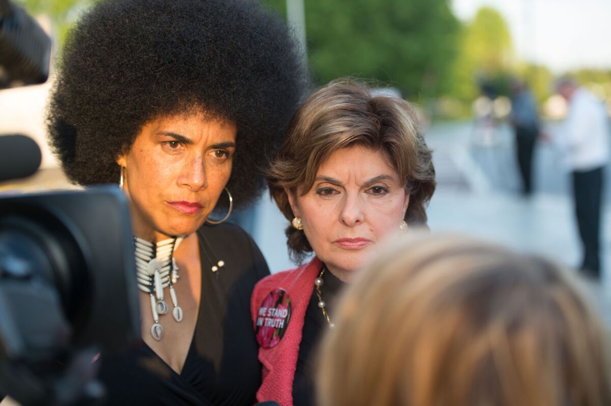 Lili Bernard, left, and Gloria Allred with protestors outside of Bill Cosby's "Far from Finished" Tour at Cobb Energy Performing Arts Center in Atlanta, Georgia in May 2015.