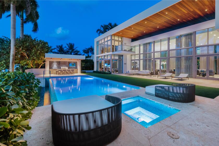 Newly renovated, the box-like abode overlooks Biscayne Bay with a swimming pool, cabana and private dock.
