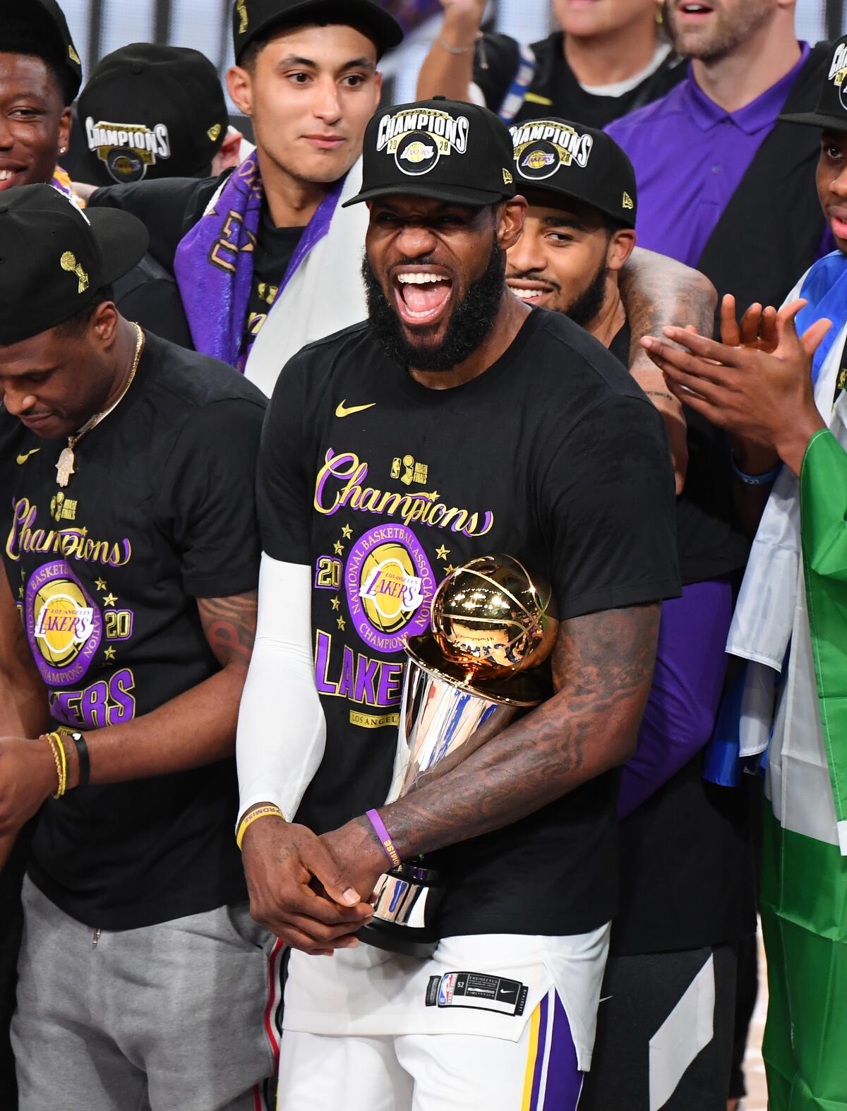 Lakers star LeBron James celebrates with his MVP trophy in Game 6 of the NBA Finals on Sunday in Orlando, Fla.