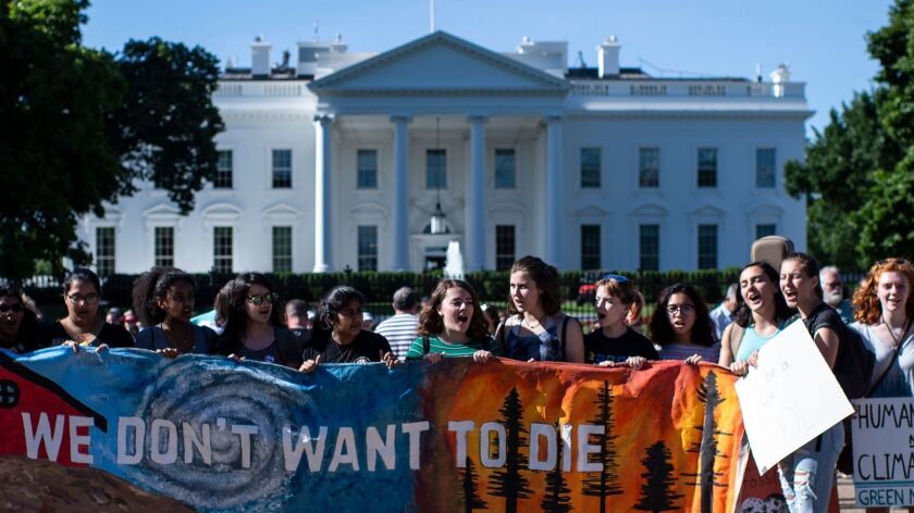 A group of teenage protesters, part of the global movement "Fridays for Future" against climate change, gather in front of the White House in Washington on May 24.