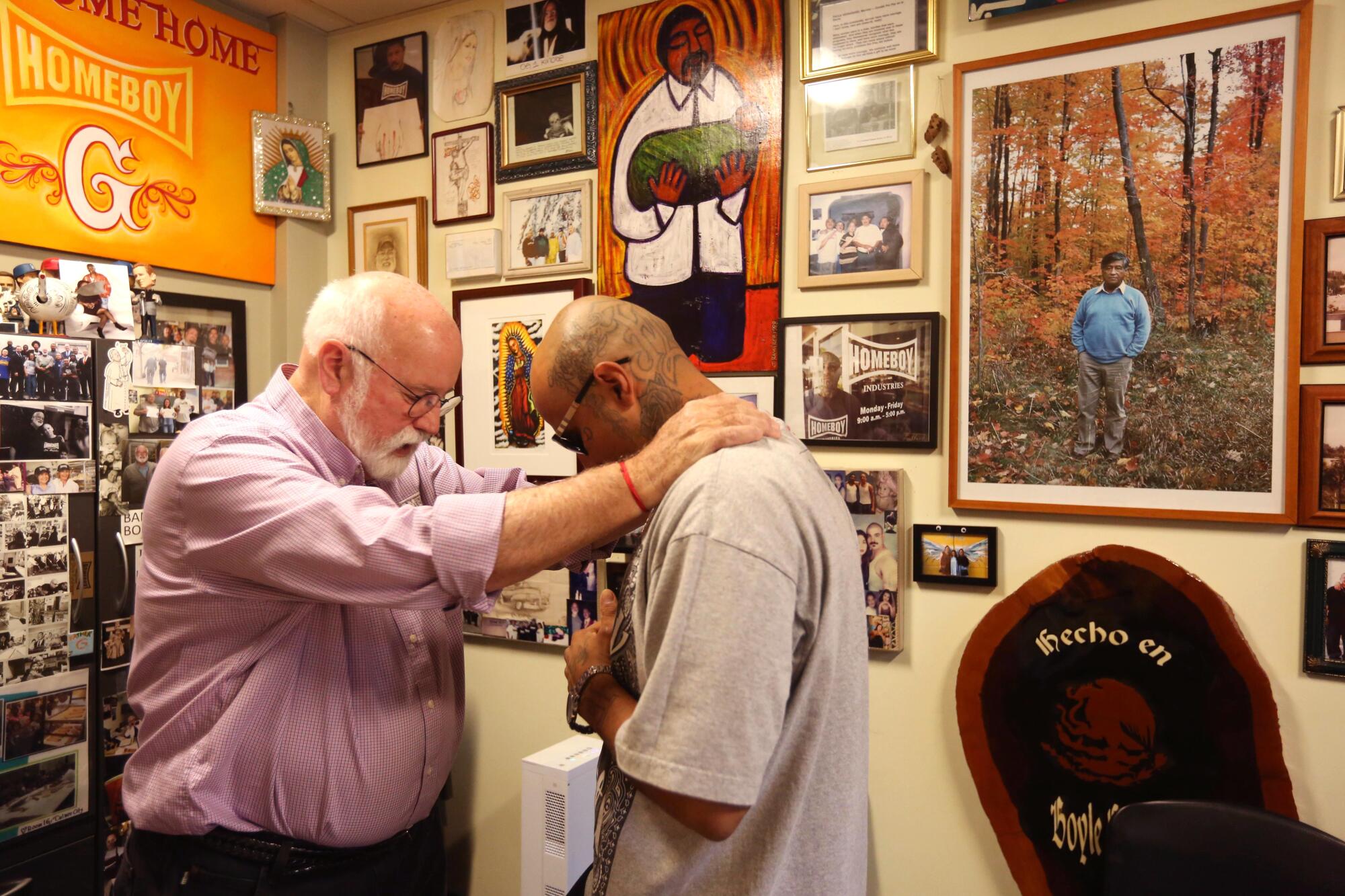 Robert Trejo, 32, right, receives a blessing from Father Gregory Boyle